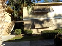 Condo building with stairs, landscaping, and shutters at 110 Cypress Woods Ct # 5C, Deltona, FL 32725
