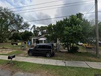 Ranch-style house with a spacious yard and mature trees at 1813 Robinson Dr, Haines City, FL 33844
