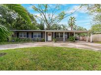 House exterior featuring a ranch style home with a well-manicured lawn and driveway at 402 Satsuma Dr, Sanford, FL 32771