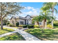 Beautiful stone and stucco home with lush landscaping and a welcoming walkway at 1004 Longley Cv, Lake Mary, FL 32746