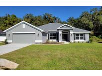 Modern two-story house with gray exterior and two-car garage at 7830 Sw 103Rd Loop, Ocala, FL 34476