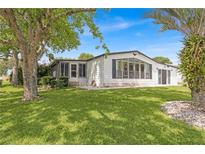 Charming single-wide manufactured home with a spacious yard at 1618 Cypress Pt, Lady Lake, FL 32159