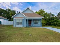 Charming light blue house with front porch at 535 W Silver Springs Pl, Ocala, FL 34475