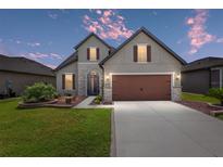 Two-story home with attached garage and landscaping at 6701 Sw 94Th Cir, Ocala, FL 34481