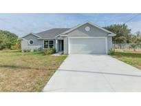 Single-story home with attached garage and driveway at 7051 Sw 64Th Ter, Ocala, FL 34476