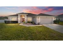 One story home with a two car garage and manicured lawn at 3235 Se 43Rd Ave, Ocala, FL 34480