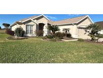 Single-story home with landscaped yard and attached garage at 12900 Se 97Th Terrace Rd, Summerfield, FL 34491