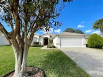Single-story home with attached garage and landscaped lawn at 15338 Sw 14Th Avenue Rd, Ocala, FL 34473