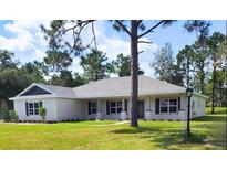 Charming single story home with gray roof and white siding at 44 Golf View Dr, Ocala, FL 34472