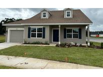 Two-story house with a porch and lawn at 4545 Se 25Th Loop, Ocala, FL 34480