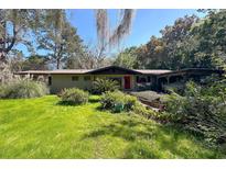 Single story home with lush landscaping and a spacious yard at 3751 Se 3Rd Ave, Ocala, FL 34471