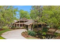 Stunning home exterior with a stone facade and pond feature at 2162 Se Mill Creek Cir, Ocala, FL 34471