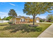 Single-Gathering home with a two-car garage and manicured lawn at 4725 Sw 62Nd St, Ocala, FL 34474