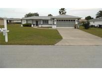 Single-story home with attached garage and driveway at 9951 Sw 62Nd Ter, Ocala, FL 34476