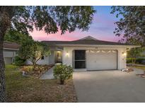 Single story home with white brick exterior and two car garage at 9145 Sw 90Th St, Ocala, FL 34481