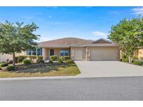 Single-story home with two-car garage and landscaped yard at 10145 Sw 89Th Loop, Ocala, FL 34481