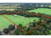 Aerial view of a house on a large lot with green pastures at 4344 Cr 542H, Bushnell, FL 33513