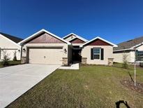 New construction home with two-car garage and landscaped lawn at 4509 Sw 90Th Pl, Ocala, FL 34476