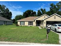 Single story home with attached garage and well-maintained lawn at 3962 Ne 58Th Cir, Silver Springs, FL 34488