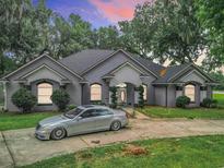 Beautiful home with a large driveway and lush landscaping at 6615 Se 158Th Pl # 6, Summerfield, FL 34491