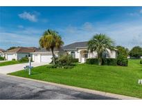 Single-story home with a two-car garage and attractive landscaping at 2260 Nw 51St Ter, Ocala, FL 34482