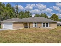 New single-story home with attached garage and neutral color scheme at 12789 Sw 86Th Cir, Ocala, FL 34473