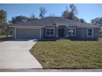 New gray house with a two-car garage and a neatly landscaped lawn at 5508 Sw 108Th St, Ocala, FL 34476