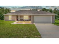 Newly built home with a two-car garage and landscaped yard at 6288 Sw 144Th Lane Rd, Ocala, FL 34473