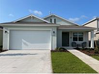Charming one-story home with a two-car garage and landscaped front yard at 7288 Sw 64Th Street Rd, Ocala, FL 34474