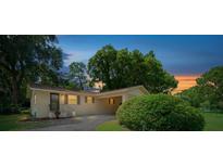 Single story house with a covered carport and well-manicured lawn at 1002 Ne 40Th Ave, Ocala, FL 34470