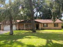 Brick ranch home with mature landscaping and trees at 2710 Sw 36Th Dr, Ocala, FL 34474