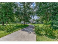 Home with circular driveway and lush landscaping at 12880 Sw 66Th St, Ocala, FL 34481