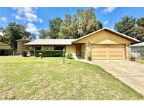 Inviting ranch-style home with a two-car garage and well-maintained lawn at 26 Juniper Pass Ln, Ocala, FL 34480