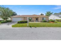 Single-story home with a two-car garage and well-maintained lawn at 11538 Sw 139Th St, Dunnellon, FL 34432