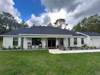 Modern farmhouse exterior with covered porch at 1965 County Road 243C, Wildwood, FL 34785
