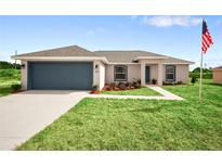 One-story home with attached garage and landscaped lawn at 17 Locust Radial Crse, Ocala, FL 34472