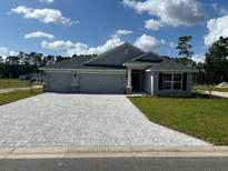 Newly built home with three-car garage and stone accents at 7160 Sw 179Th Court Rd, Dunnellon, FL 34432
