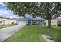Single-story home with attached garage and mature landscaping at 9698 Sw 96Th St, Ocala, FL 34481