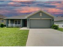 One-story house with a green exterior and a two-car garage at 4426 Nw 2Nd Ct, Ocala, FL 34475