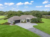 Aerial view of a single-Gathering home with a large lawn at 1620 Nw 73Rd Ter, Ocala, FL 34482
