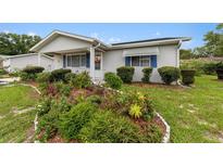 Cute ranch home with landscaped front yard and well-maintained lawn at 10978 Sw 83Rd Ave, Ocala, FL 34481