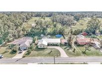 Aerial view of single Gathering home with driveway and yard at 6340 Se 127Th Pl, Belleview, FL 34420