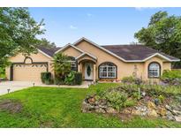 Charming ranch home with mature landscaping and a two-car garage at 86 Fisher Ter, Ocklawaha, FL 32179