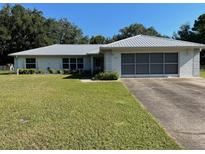 Ranch-style home with metal roof and spacious yard at 20225 Sw Beach Blvd, Dunnellon, FL 34431