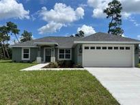 Newly built home with two-car garage and landscaping at 15443 Sw 23Rd Ct, Ocala, FL 34473