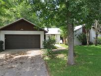 Ranch-style home with attached garage and mature landscaping at 1536 Se 43 Ter, Ocala, FL 34471