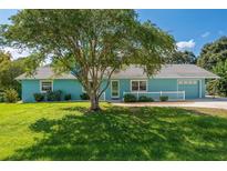 Charming light blue single story home with a spacious lawn at 6212 Ne 26Th Ave, Ocala, FL 34479