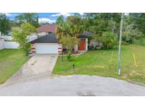 Single-Gathering home with attached garage and a palm tree at 25 Cedar Ter, Ocala, FL 34472