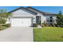 One-story home with white garage door and stone accents at 9462 Sw 52Nd Loop, Ocala, FL 34481