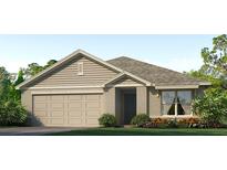 One-story home with beige siding, gray roof, and landscaping at 9872 Se 161St Lane Rd, Summerfield, FL 34491